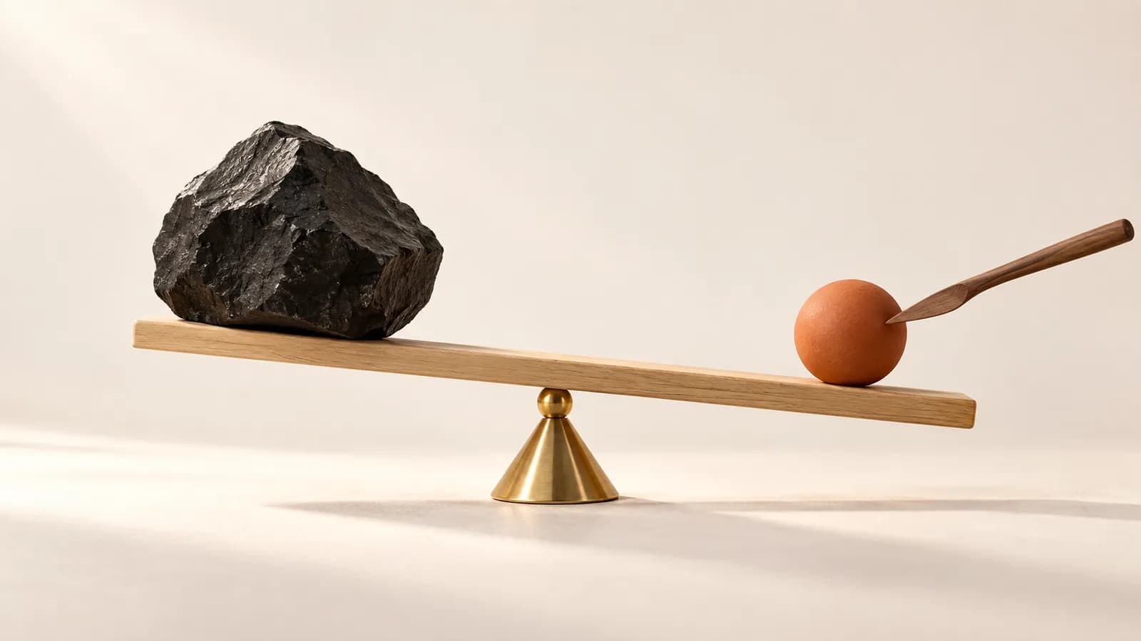 A tilted oak balance beam being levelled by sliding a terracotta counterweight along it