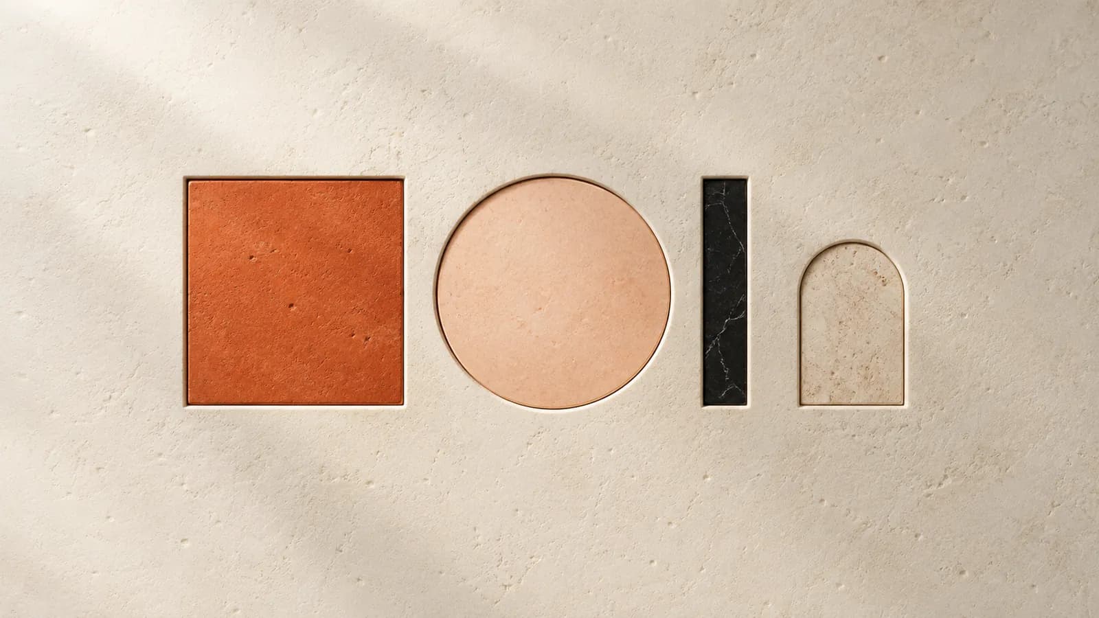 Terracotta, peach and black inlays set flush into a smooth limestone wall