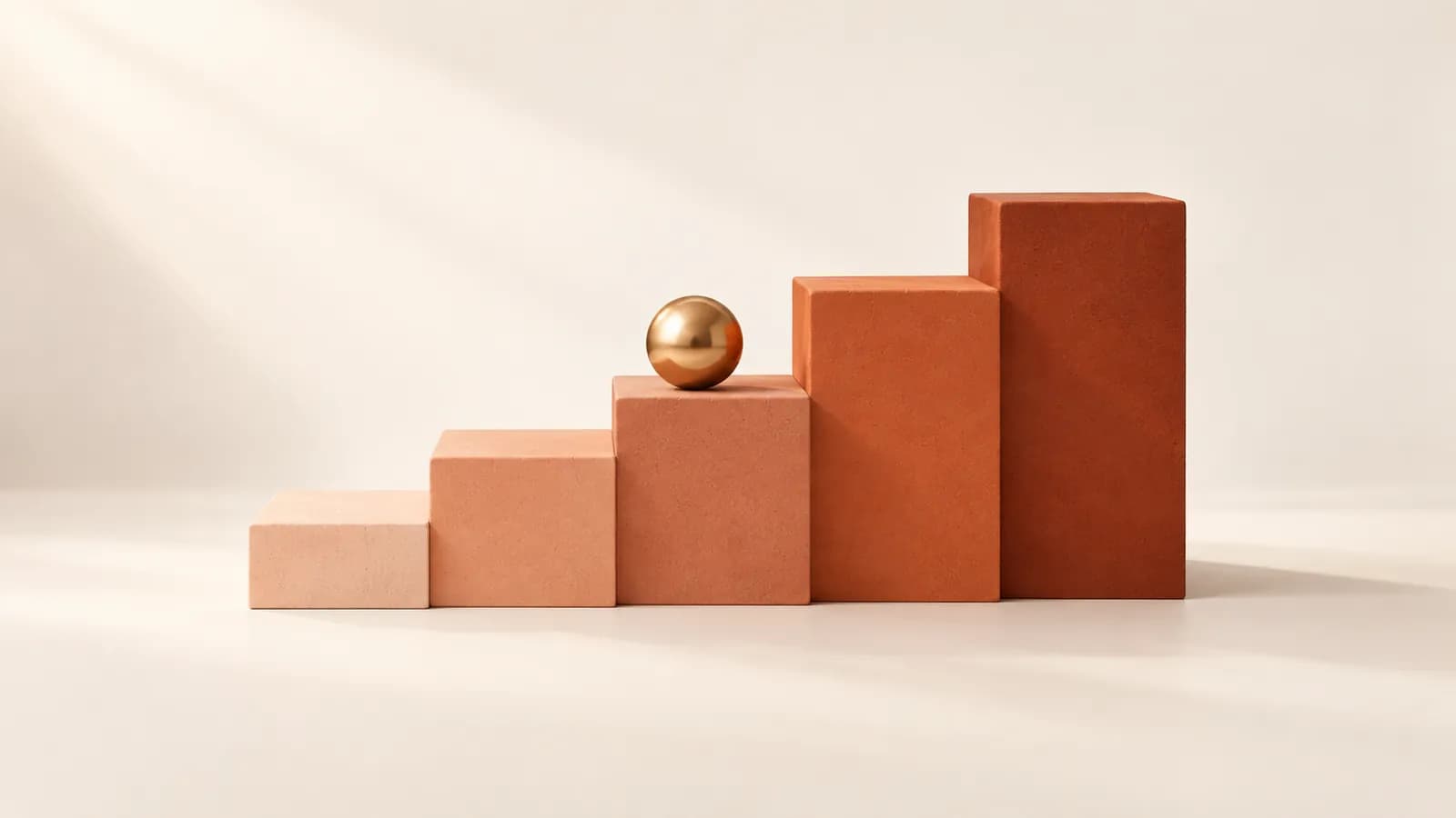 Graduated ceramic steps from peach to terracotta, with a brass sphere on a middle step