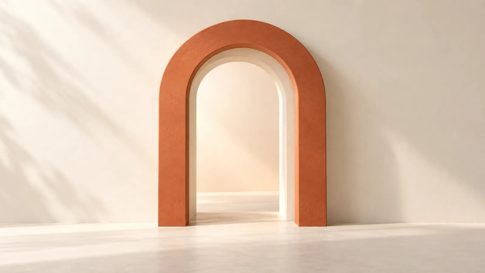 A terracotta arch frame fitted in front of a plain plaster archway, slightly offset